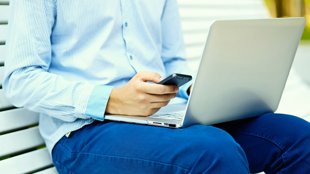 A business executive with a laptop and a mobile phone